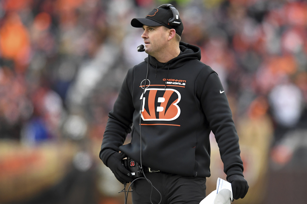 Coach-to-quarterback communications systems replaced hand signals and player substitutions as methods for coaches to relay play calls to quarterbacks. (AP/Nick Cammett)