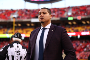 General Manager of the Chicago Bears, Ryan Poles, walking on an NFL field.